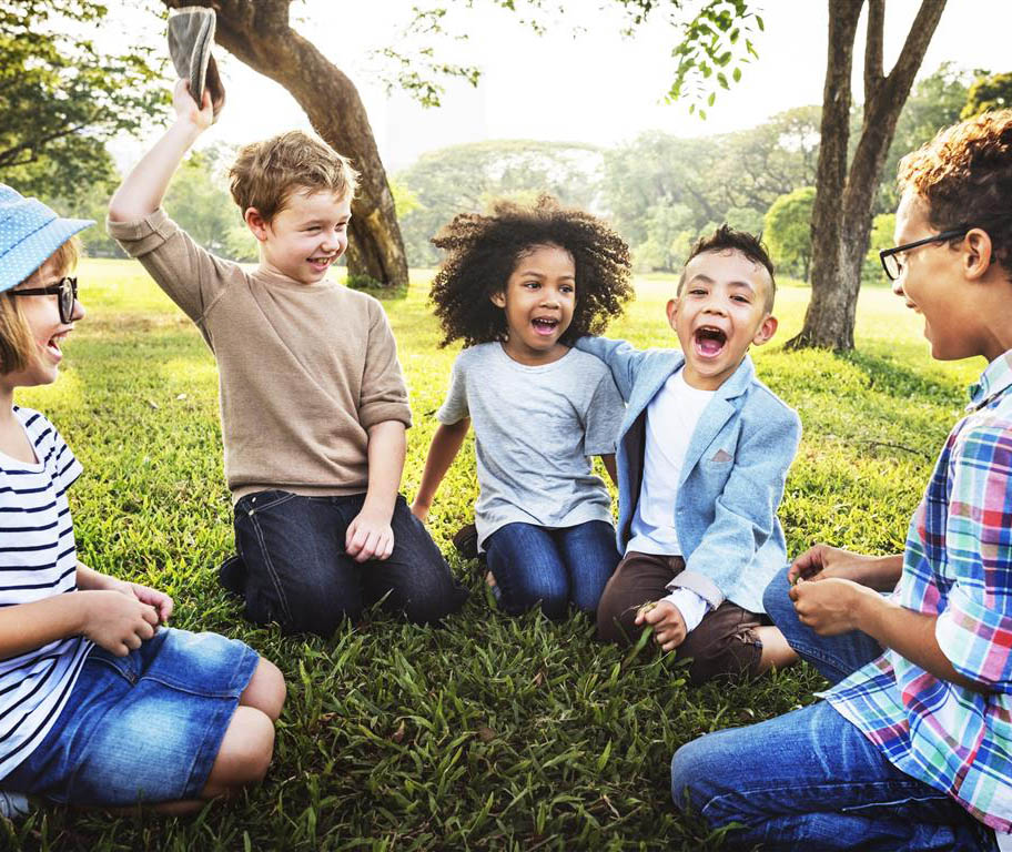 Kids smiling on grass
